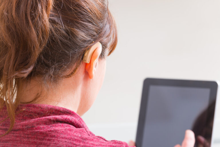 Hearing-Impaired woman watches Facebook Live's closed captioning